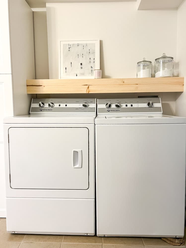 A residential laundry space with a washer and dryer rental installed side by side.